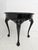 Elegant Italian Rococo side table featuring richly carved shell and foliate motifs, cabriole legs and a dramatic black...