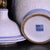 Pair of Chinese White Glazed Porcelain Jars With Floral Panels & Gilt Finials For Sale - Image 9 of 9