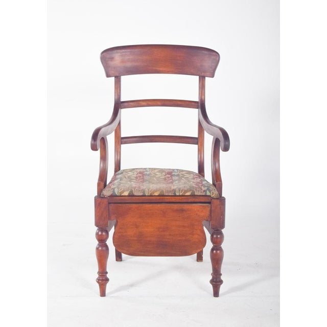 Chair with striped upholstery. With a backrest on three curved crossbars and gently arched arms, the seat upholstered in...