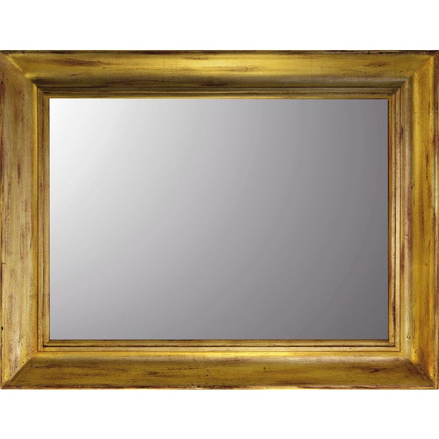 Dating from the 1980s, this Italian wall mirror features a substantial rectangular wooden frame with a warm gold-leaf...