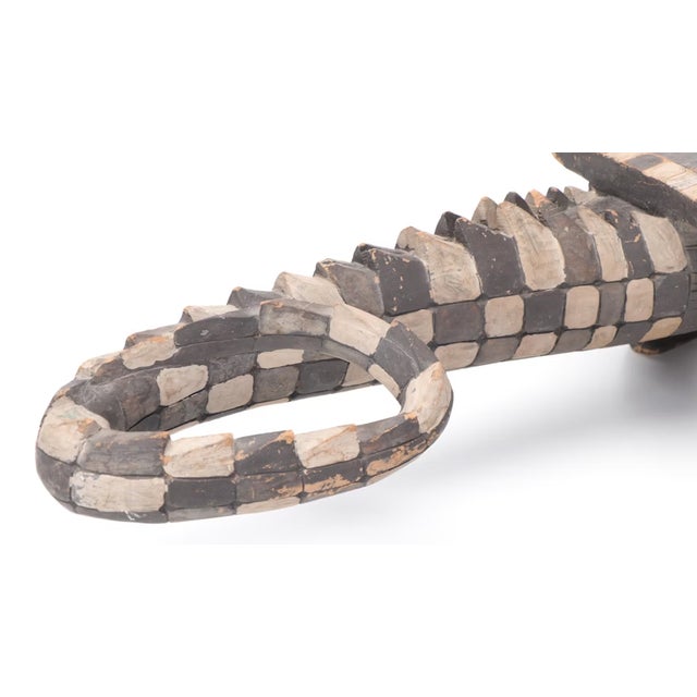 A striking nod to Papua New Guinea artistry, this hand-carved wood alligator is finished in rich polychrome and...