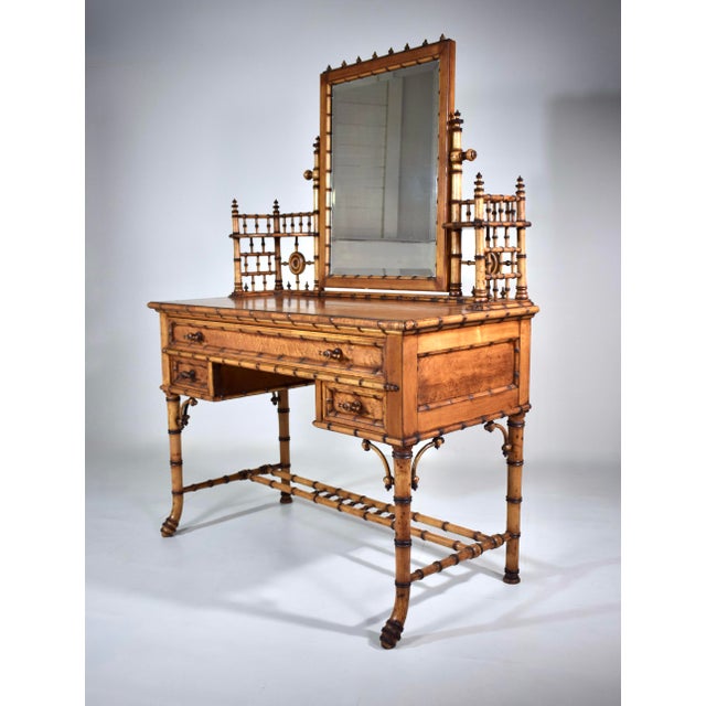 Part of a rare seven-piece collection of American Aesthetic Movement Birdseye Maple faux bamboo bedroom furniture. The...