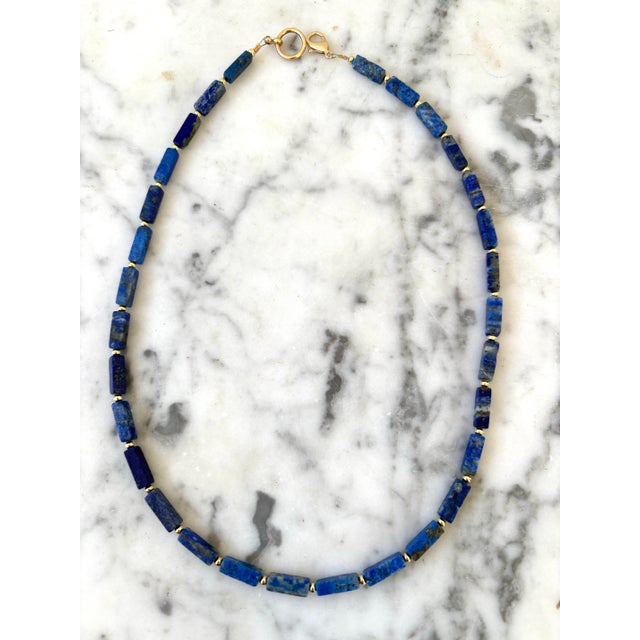 This gorgeous beaded lapis necklace made from rectangular beads and gold tone spacers is a springtime staple. Dress up a...