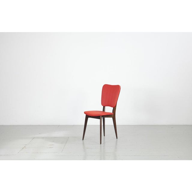 Kitchen chair with red synthetic leather cover from the 1960s. The beech wood was stained dark. The cover is still in very...