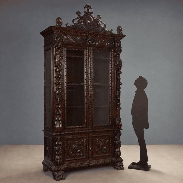 Neobaroque walnut display cabinet from late 19th century Italy, featuring an imposing structure and finely carved details....