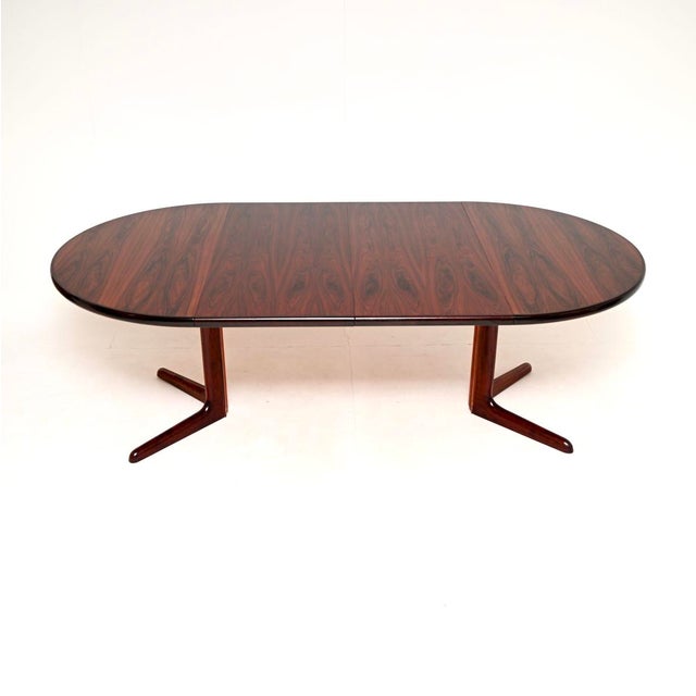 A stylish and top quality Danish vintage extending dining table, made in Denmark and dating from the 1960’s. This has a...