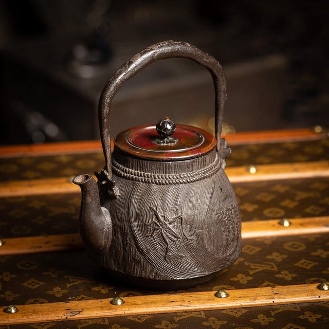 Antique 19th Century Japanese cast iron Ryubundoa carved tetsubin kettle. The cylindrical iron body is decorated in low...