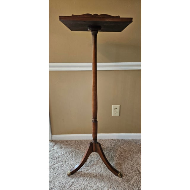 Antique plant stand pedestal. Beautifully turned base with brass claw feet legs. The platform has lovely carved detail...