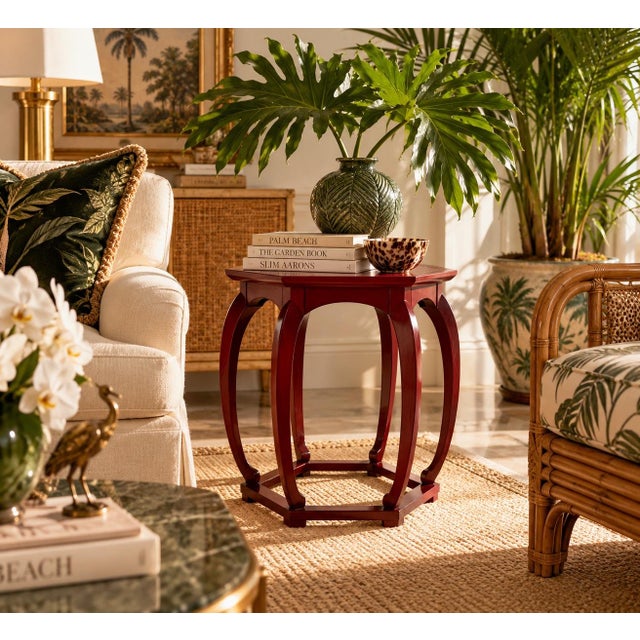 Elegant vintage hexagonal side table by Baker Furniture, featuring a rich red lacquer finish and beautifully sculpted...