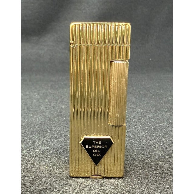 Dunhill Rollalite Gold Tone Lighter, in box Classic ribbed design with rolling bar for easy lighting The Superior Oil Co,...