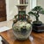 This is a vintage Royal Satsuma style Japanese earthenware vase featuring geisha girls with gilded handles. This porcelain...