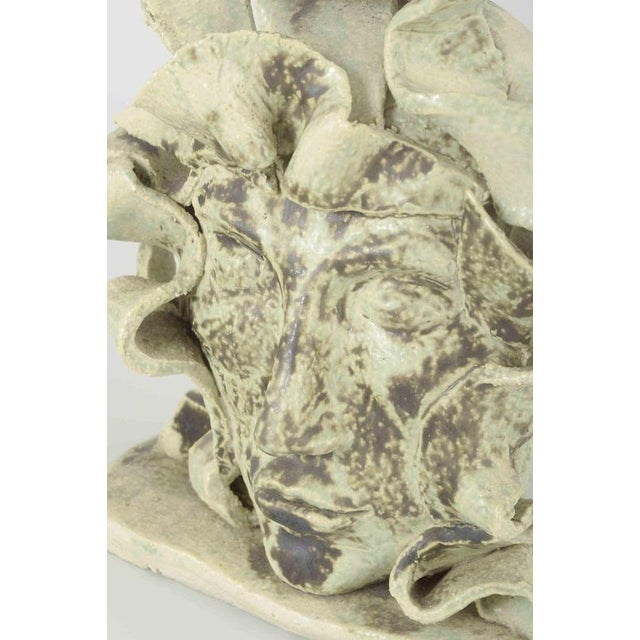 Mh, european studio potter sculpture, 1980s. Unique hand-modelled stoneware head sculpture with light greenish glaze and...