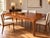 Elegant mid-century walnut dining table by John Widdicomb, dating to approximately the 1960s–early 1970s. Featuring a...