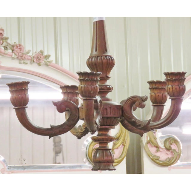 This exquisite antique carved walnut chandelier is a rare and elegant lighting piece that captures the grandeur of Old...