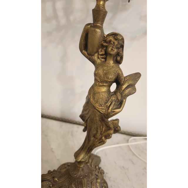 A monumental vintage thirteen-light electrified candelabrum rendered in heavily ornamented cast brass. The central...