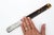 An antique, circa 1892, page turner or paper knife with a sterling silver mounted ribbed handle and faux tortoiseshell...