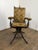 An exceptional and increasingly scarce late 19th to early 20th century American mechanical barber or medical chair,...