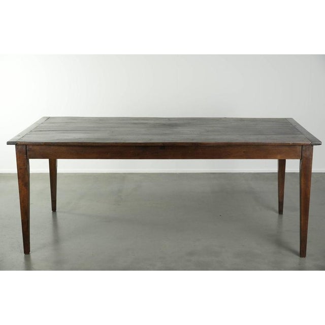 Offered by ByThijs: this antique French oak dining table from the early 19th century with a beautiful dark color scheme...