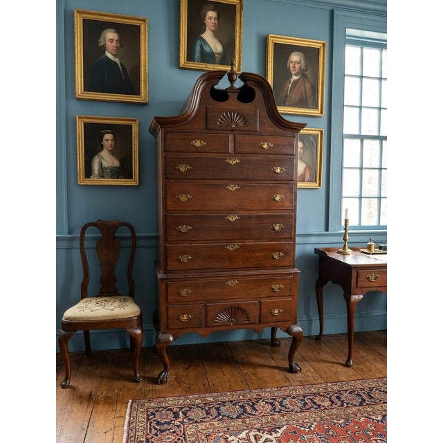 It features a classic broken-arch pediment (bonnet top) with central cutouts, fan/shell carvings on both the upper and...