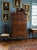 It features a classic broken-arch pediment (bonnet top) with central cutouts, fan/shell carvings on both the upper and...