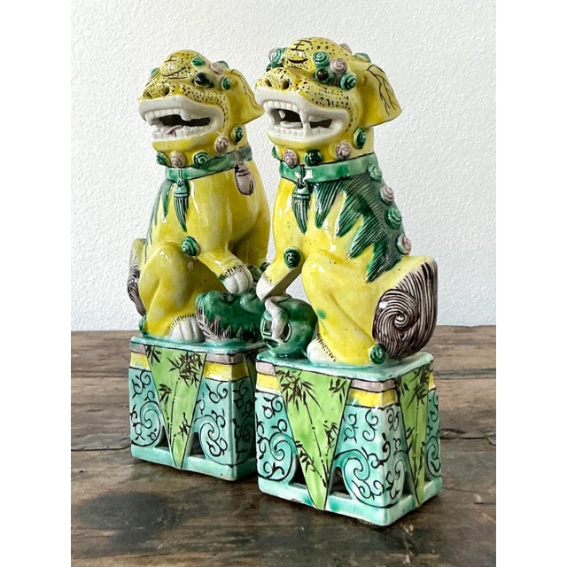 This striking pair of vintage guardian lions, traditionally known as Foo Dogs, is a vibrant example of mid-to-late 20th-...
