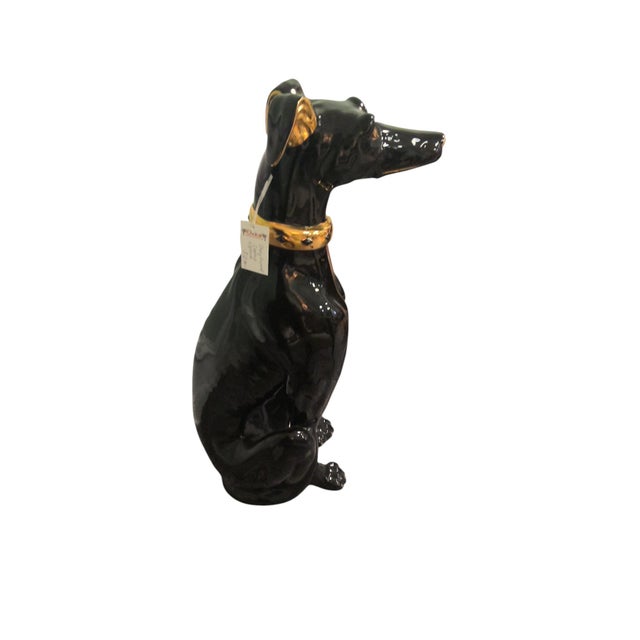Italian black glazed ceramic Greyhound statue. In a majestic seated pose is this vintage Italian glazed ceramic Greyhound...