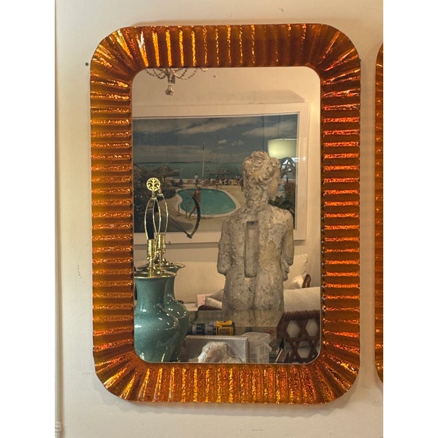 Vintage pair of contemporary orange glass wall mirrors, scalloped wavy edges. Made in Italy by Linea Vetro SAS. Made in...