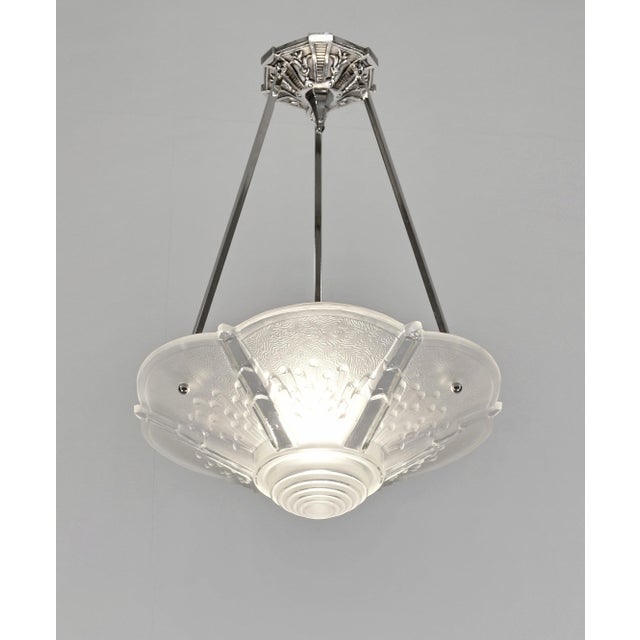 MULLER FRERES A French 1930 art deco hanging fixture in nickel plated solid bronze or brass holding a beautiful bowl by...