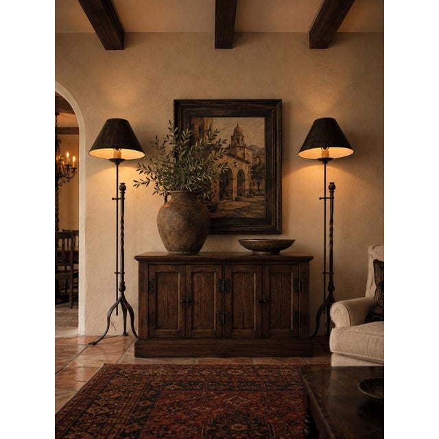 Striking pair of vintage hand-forged iron floor lamps featuring a dramatic blend of French Gothic and Spanish Revival...