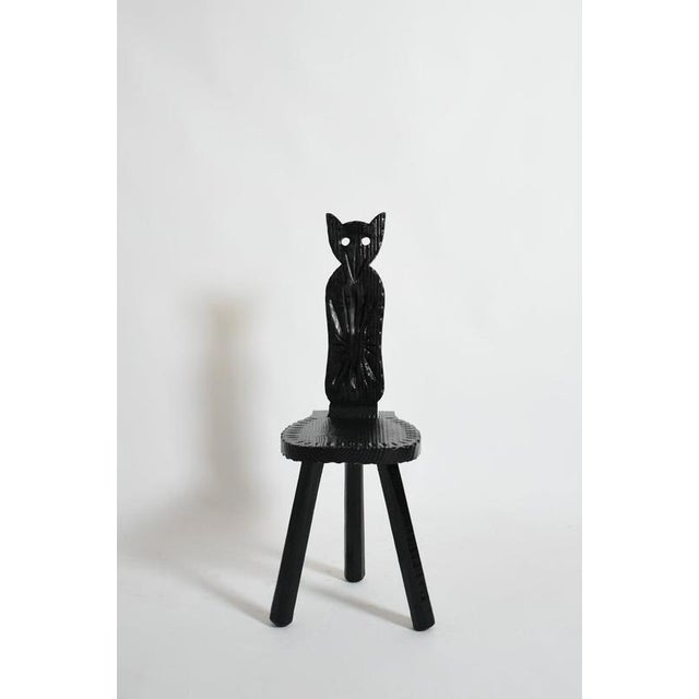 Pair of brutalist ebonised wood owl chairs, 1960s. Zoomorphic brutalist pair of chairs with hinged backrests featuring an...