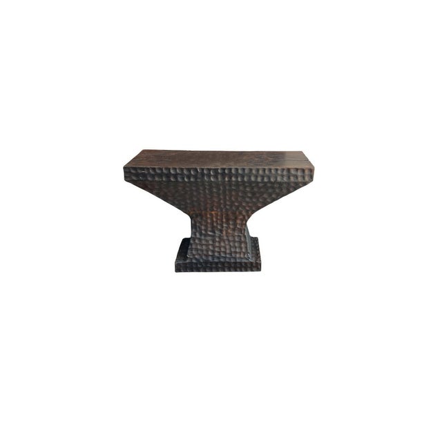 A striking console table handcrafted from solid teak wood, defined by its bold architectural silhouette and richly...