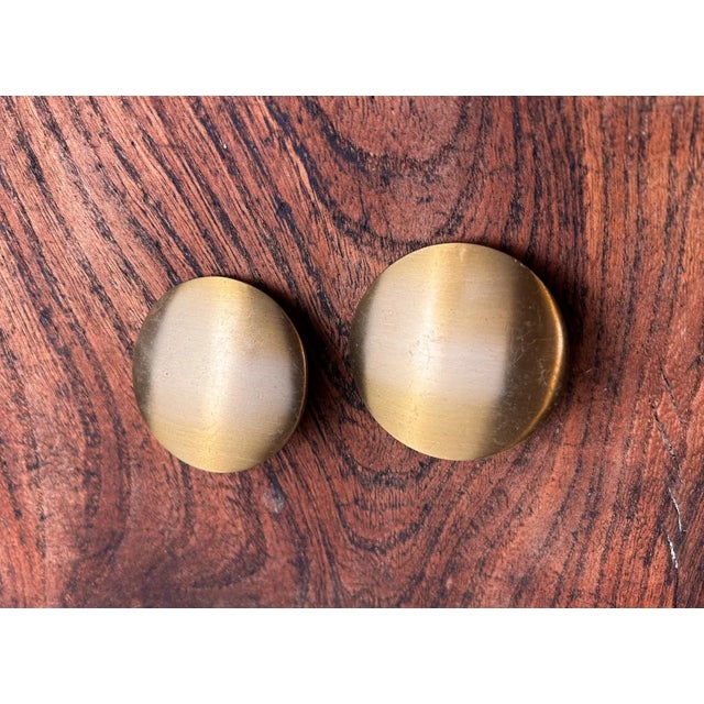 Very unique MCM vintage drawer pulls from Europe. Brushed brass surface in a thin circle, they have an angled mount shown...