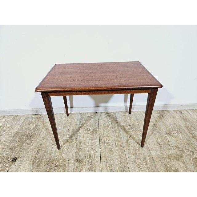 The elegant coffee table is a classic example of mid-20th century Scandinavian design. Made of warm teak wood, it...