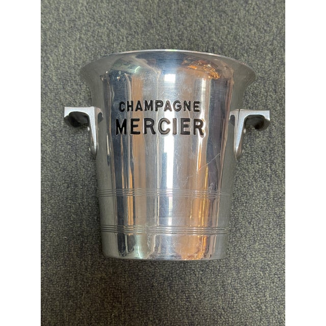 Design Plus Gallery presents a Vintage Champagne Mercier Metal Ice Bucket. The ice bucket has black inset lettering,...