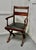 Arts & Crafts X-frame mahogany desk chair. The chair is set on X-framed Legs, a very strong design, it has elegant arm...