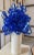 Whimsical heat formed ribbons of cobalt blue acrylic woven together and mounted upon a cylindrical marble base.