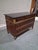 An elegant French Empire period commode crafted in richly figured mahogany and crowned with its original black marble top....