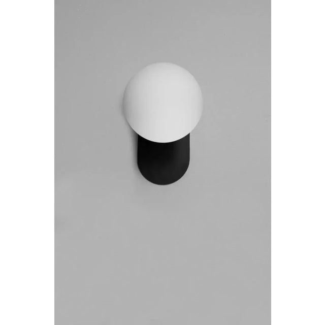 Adrion wall sconce sm by schwung dimensions: w 15 x d 16.1 x h 23 cm materials: black gunmetal, frosted glass. All our...