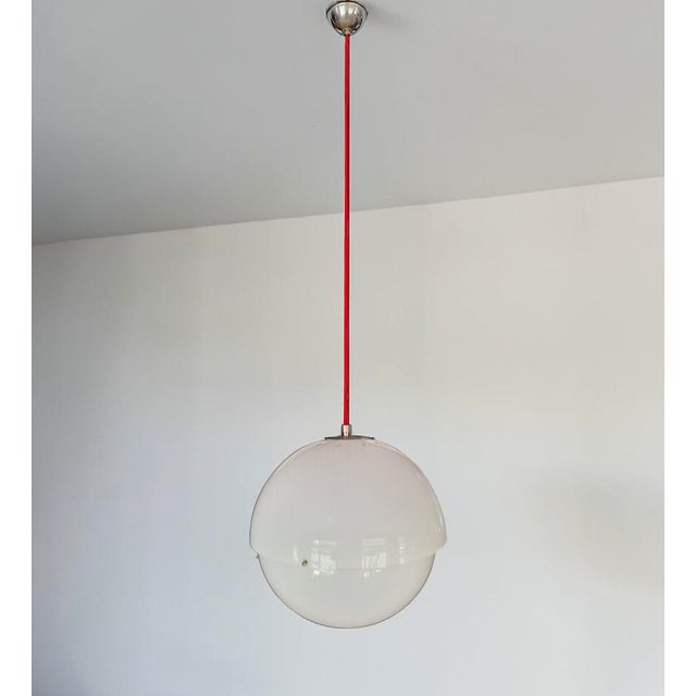 Pendant lamp composed of two hemispherical methacrylate lampshades joined together with nickel-plated brass screws....