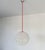 Pendant lamp composed of two hemispherical methacrylate lampshades joined together with nickel-plated brass screws....