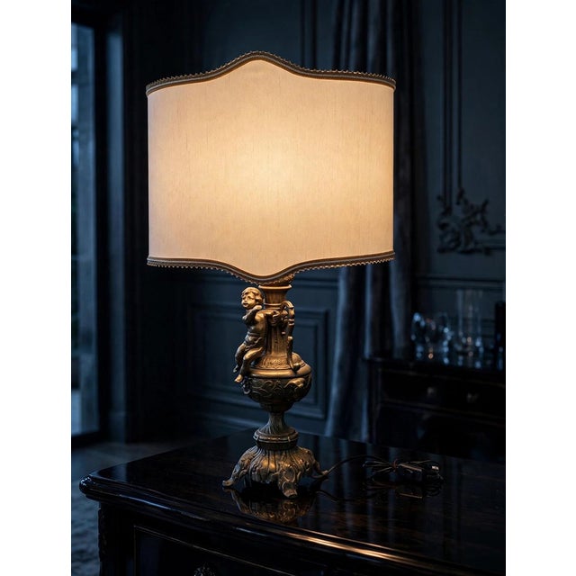 This Art Nouveau brass lamp features an elegant and refined design, featuring a delicate cherub that enhances the overall...