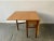 A wide and substantial extending dining table with the original wood grain laminate table top and 2 drop leaves. Supported...