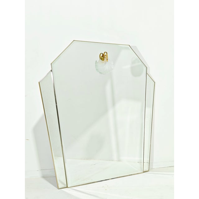 A large wall mirror. Its gold frame features an architectural silhouette with side panels. Details: The frame is made of...