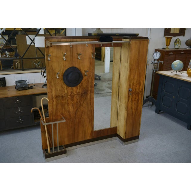This monumental Art Deco coat rack elegantly graces the entrance to your home. Crafted from walnut wood with visible grain...
