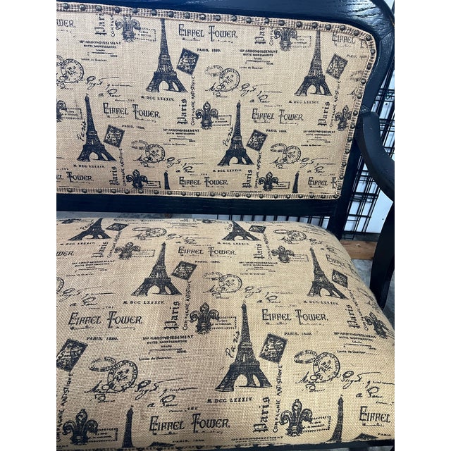 Antique lion paw Empire reupholstered settee. This is featuring a black painted frame and fabric printed with Eiffel Tower...