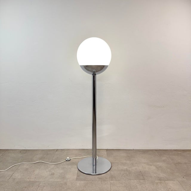1970s floor lamp. Chrome-plated metal and polished opal glass. Foot switch (see photos). For use with standard E27 bulbs....