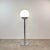 1970s floor lamp. Chrome-plated metal and polished opal glass. Foot switch (see photos). For use with standard E27 bulbs....
