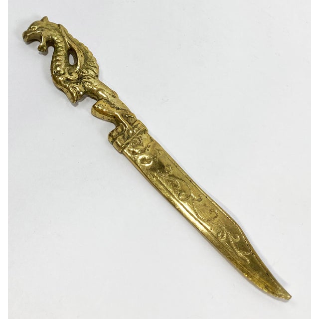 Vintage letter opener made of solid brass featuring dragon handle with scroll etchings down blade. Natural patina. Knife...