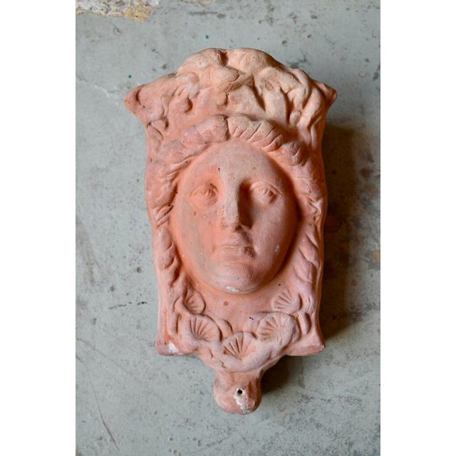 Made of thick terracotta, this pair of antique planters can be mounted on the wall. They have a lovely patina from age....