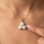 An enchanting three-stone design featuring round-cut natural opals arranged in a graceful trefoil formation, secured in a...